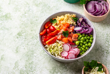 Balanced healthy bowl with vegetables and salmon