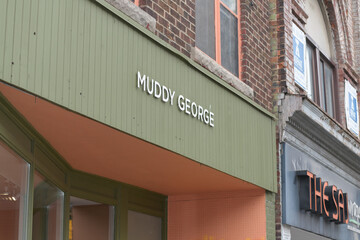 Fototapeta premium exterior building facade and sign of Muddy George, a men's clothing store, located at 973 Bloor St W, Toronto