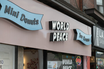 Fototapeta premium close-up of sign outside World Peace Café & Eatery located at 993 Bloor St W, Toronto
