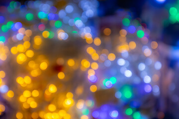 Colorful bokeh lights create a festive atmosphere, blending warm yellows and cool blues, evoking a sense of celebration and joy during holiday gatherings and special occasions