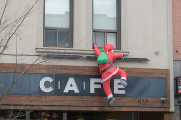 Fototapeta premium holiday Santa inflatable outside CAFE Dispensary, a cannabis store, located at 932 Bloor St W, Toronto