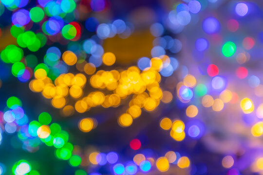 Colorful bokeh background with vibrant lights in various hues creating a festive atmosphere, ideal for holiday celebrations and joyful occasions, perfect for design projects