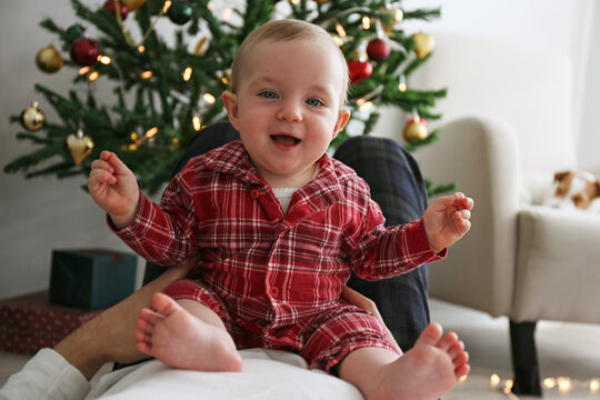 POV: joyful little baby with her father on Christmas morning. Copy space, background.