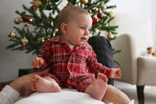 POV: joyful little baby with her father on Christmas morning. Copy space, background. - Powered by Adobe