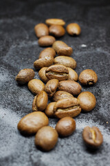 Close-up of a group of roasted coffee beans on a black baking tray background