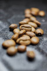 Close-up of a group of roasted coffee beans on a black baking tray background