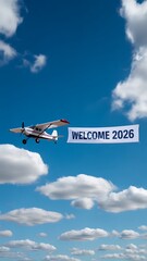 Airplane with banner and writing the phrase "Welcome 2026" in smoke in the sky. Abstract image, texture, pattern background, wallpaper, cover and screen for smartphone, PC, laptop, 9:16 and 16:9 forma