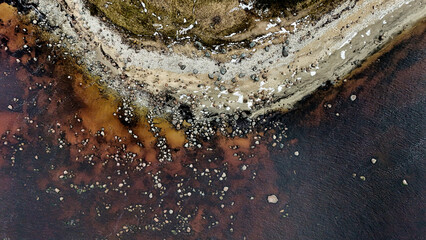 Abstract Aerial Top-Down View of Rocky Shoreline and Dark Water