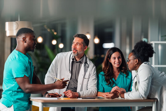 Diverse medical team collaborating on healthcare discussion - Powered by Adobe