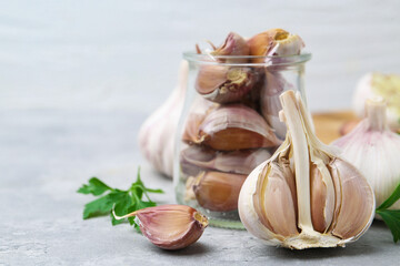 Garlic and parsley on light table, closeup. Space for text