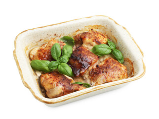 Tasty cooked chicken thighs with basil in baking dish isolated on white