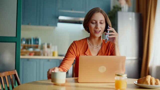 Smiling girl calling cellphone drinking coffee at breakfast closeup. Happy woman