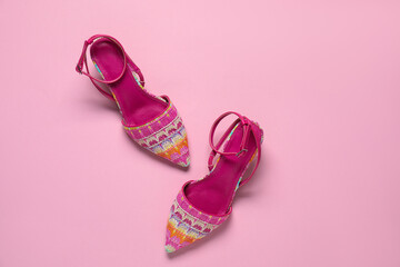 Pair of stylish shoes on pink background, top view