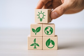 Sustainable energy future depicted with wooden blocks featuring green icons of nature and renewable resources