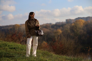 Fototapeta premium Woman enjoying a sunny day in a natural landscape