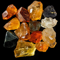 Colorful gemstones collection with various hues on a black background
