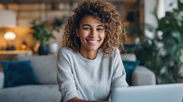 Smiling African American Woman Working From Home with Laptop in Cozy Living Room - Powered by Adobe