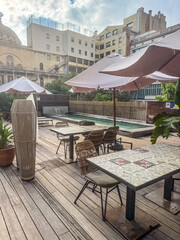 Stylish Outdoor Rooftop Cafe Dining Area with Umbrellas and Wooden Deck