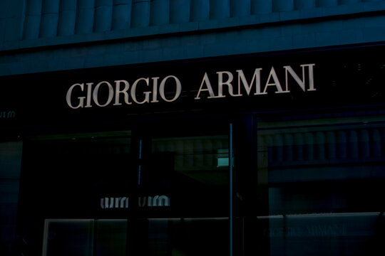 Vienna, Austria, Europe - Nov 08, 2025: Giorgio Armani store sign with white lettering on a black facade at night in vienna