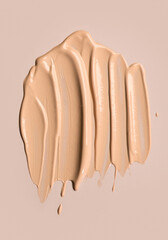 Foundation, concealer, face makeup smudge, smears. Cosmetic liquid foundation or cream beige color smudges, stroke. Contouring, Make up background. Foundation texture surface, bb, cc cream. 