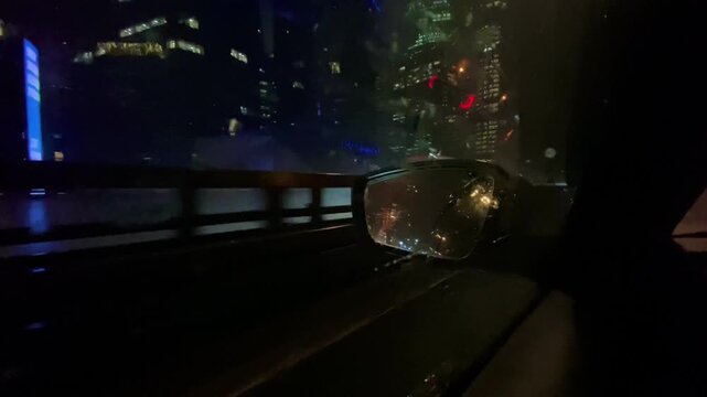 Wet cityscape with glowing neon and drifting headlights