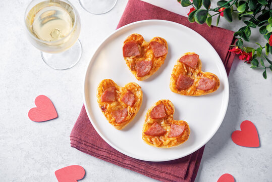 Pizza mini with salami in the form of hearts for Valentine's day holiday on a white background