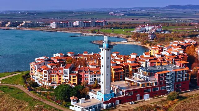 Vivid scenery of residential buildings with adjacent lighthouse. Drone footage around Marina Cape complex in Aheloy, Bulgaria.
