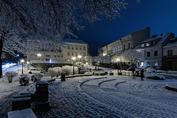 Snowy Town Square at Night with Illuminated Old Buildings, Bielsko Biala, Poland, City background...
