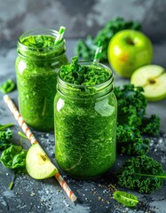 Green smoothies in mason jars with apple & kale. Healthy drink on stone background