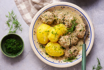 Meatballs in a creamy dill sauce with boiled potatoes and cabbage salad..top veiw