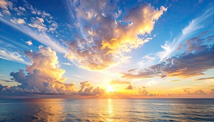 Vivid sunset over calm ocean, painting the sky with golden hues and fluffy clouds