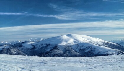 Obraz premium Winter Landscape with Clear Blue Sky, Cirrus Clouds, and Snow-Covered Mountain Range for Advertising
