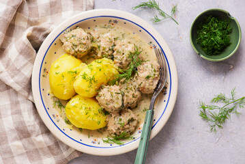 Meatballs in a creamy dill sauce with boiled potatoes and cabbage salad..top veiw