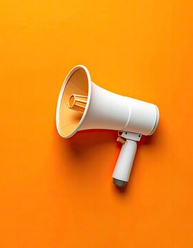 White megaphone on bright orange background, announcing message