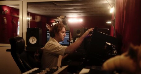 Sound engineer working at mixing console in recording studio - Powered by Adobe