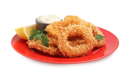 Deep fried squid rings with parsley, sauce and slice of lemon isolated on white