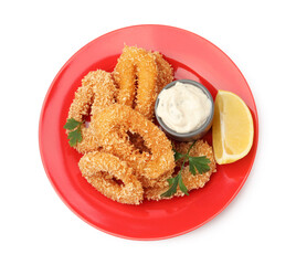 Deep fried squid rings with parsley, sauce and slice of lemon isolated on white, top view
