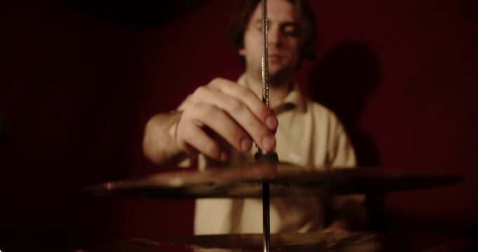 Professional musician assembling hi hat cymbals in recording studio
