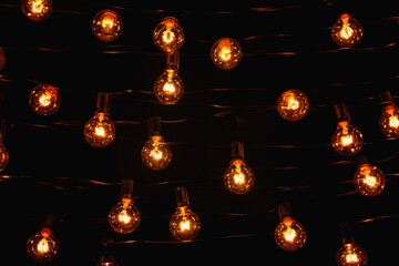 Background - electric garland with incandescent bulbs, yellow warm light
