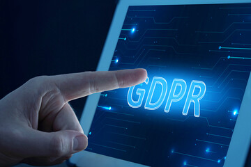 General Data Protection Regulation. Man using tablet computer with GDPR on display, closeup. Privacy security