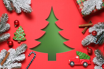 Merry Christmas and Happy New Year! Greeting card with Christmas tree cut in red paper, festive ornaments, fir branches and cookies
