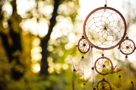 Dream catcher with feathers and beads outdoors