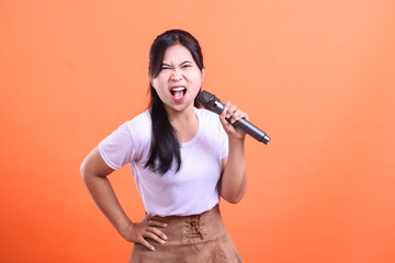 A young woman sings with a microphone, her face showing intense passion and expressive emotion,...