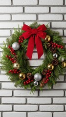 Traditional festive Christmas wreath with vibrant red bow gold silver ornaments on a white brick wall
