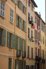 Yellow vintage house with green windows and clothes