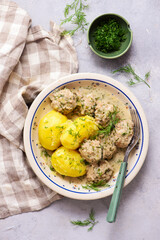 Meatballs in a creamy dill sauce with boiled potatoes and cabbage salad..top veiw