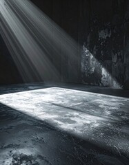 Dramatic light streams into a dark, empty room, illuminating the corner and floor