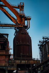 Industrial furnace at dusk with striking silhouette against the evening sky