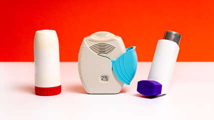 Set of asthma inhalers for asthma and COPD patients. Bronchodilator medicine with salbutamol for patients with asthma, allergy and Chronic Obstructive Pulmonary Diseaseon on orange background.