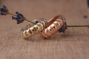 a pair of wedding rings on a sprig of lavender